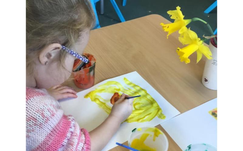 Child painting a daffodil